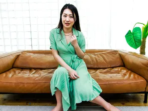 Japanese MILF Megumi Satuki shows her body and poses on a couch